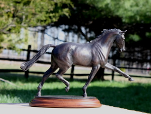 Dressage horse sculpture in bronze of horse performing extended trot